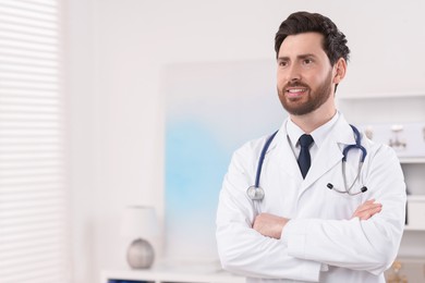 Medical consultant with stethoscope in clinic, space for text