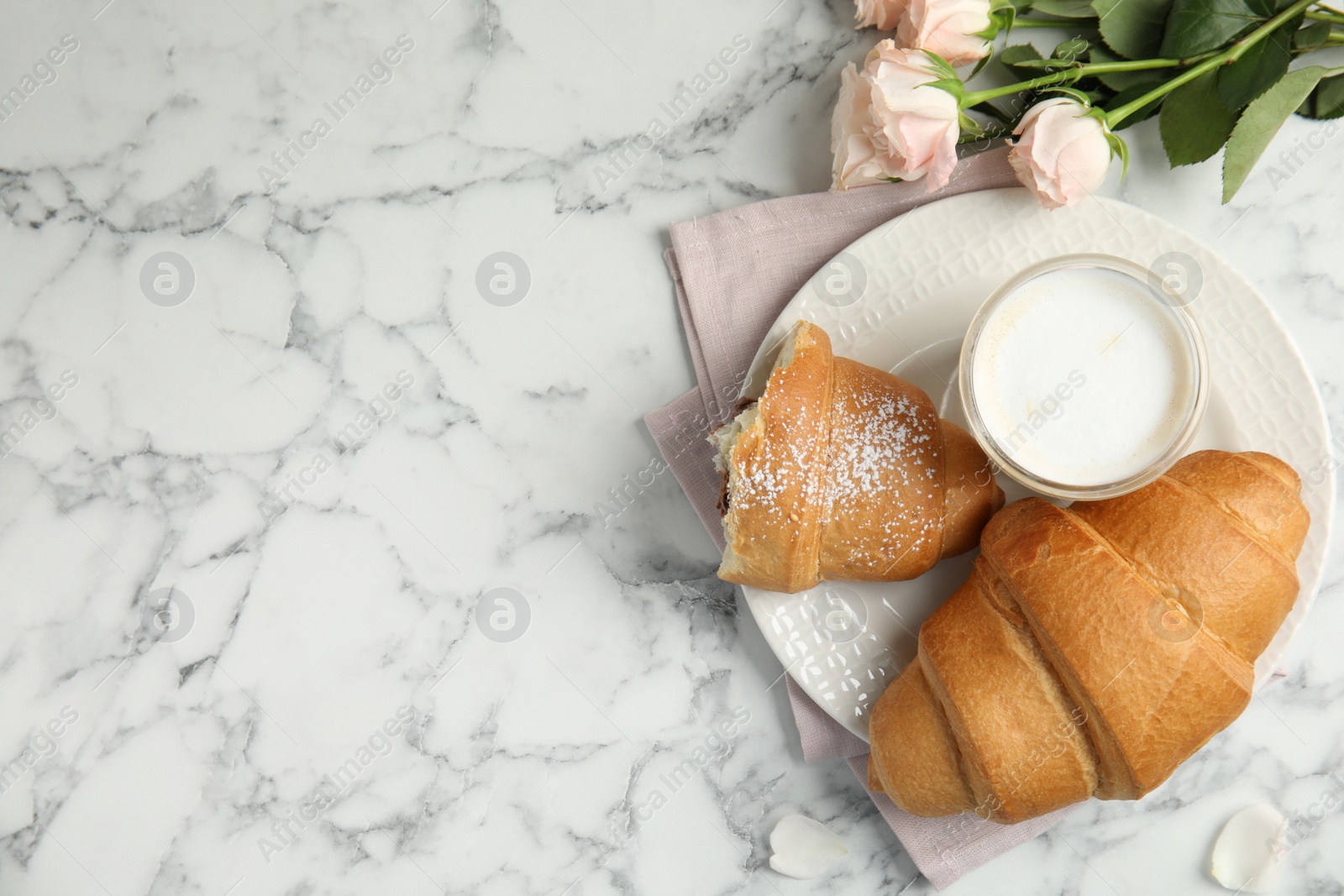 Photo of Flat lay composition with tasty croissants, latte and roses on white marble table. Space for text