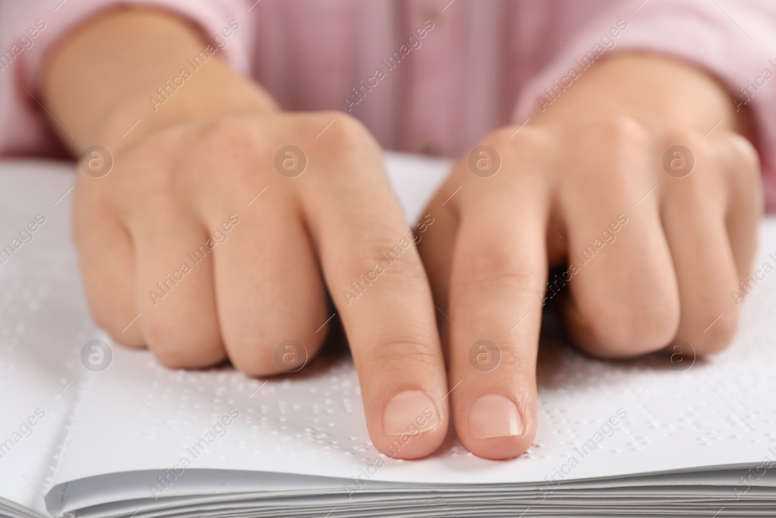 Photo of Blind person reading book written in Braille, closeup