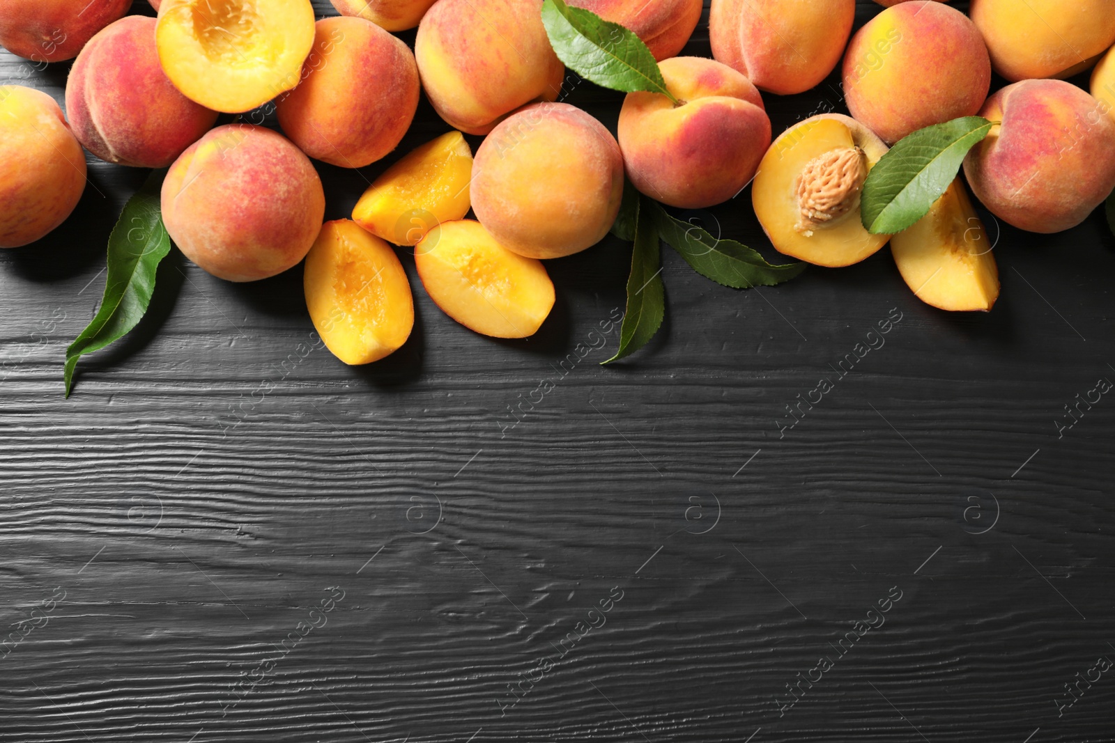 Photo of Flat lay composition with ripe peaches on wooden background