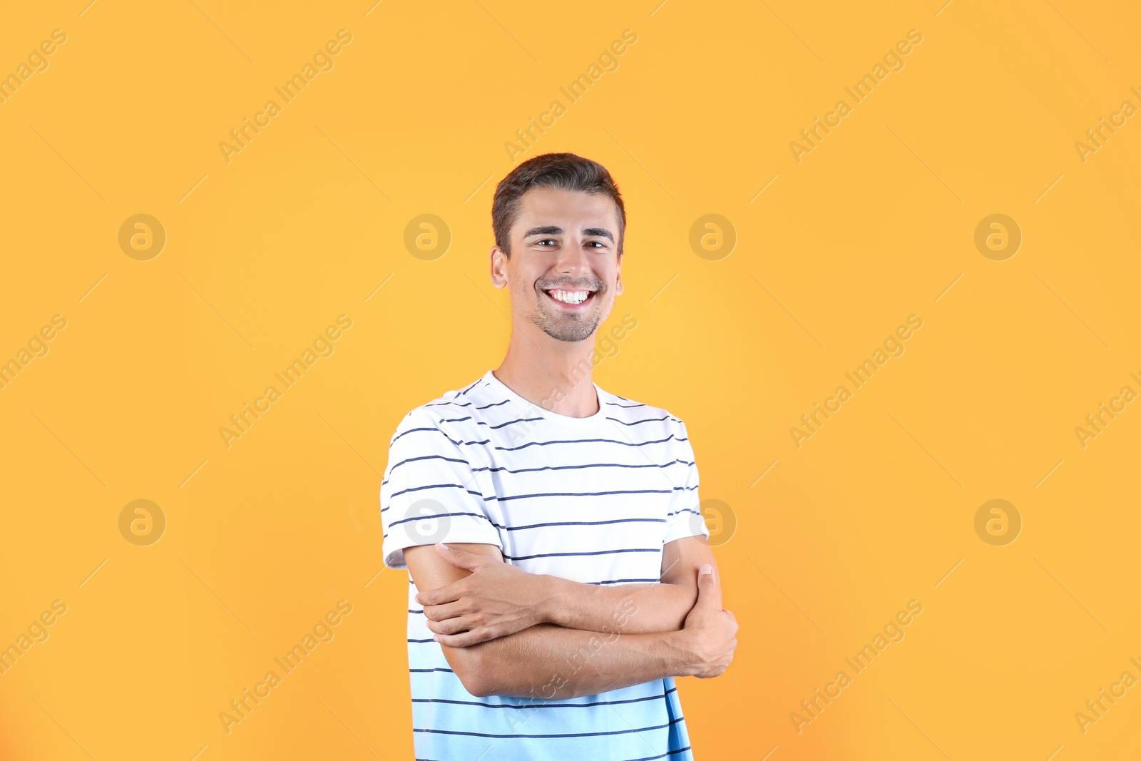 Photo of Portrait of handsome young man smiling on color background