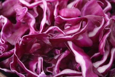 Photo of Shredded fresh red cabbage as background, closeup