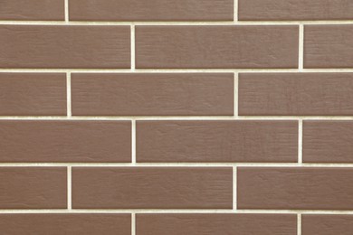 Texture of brown brick wall tiles as background