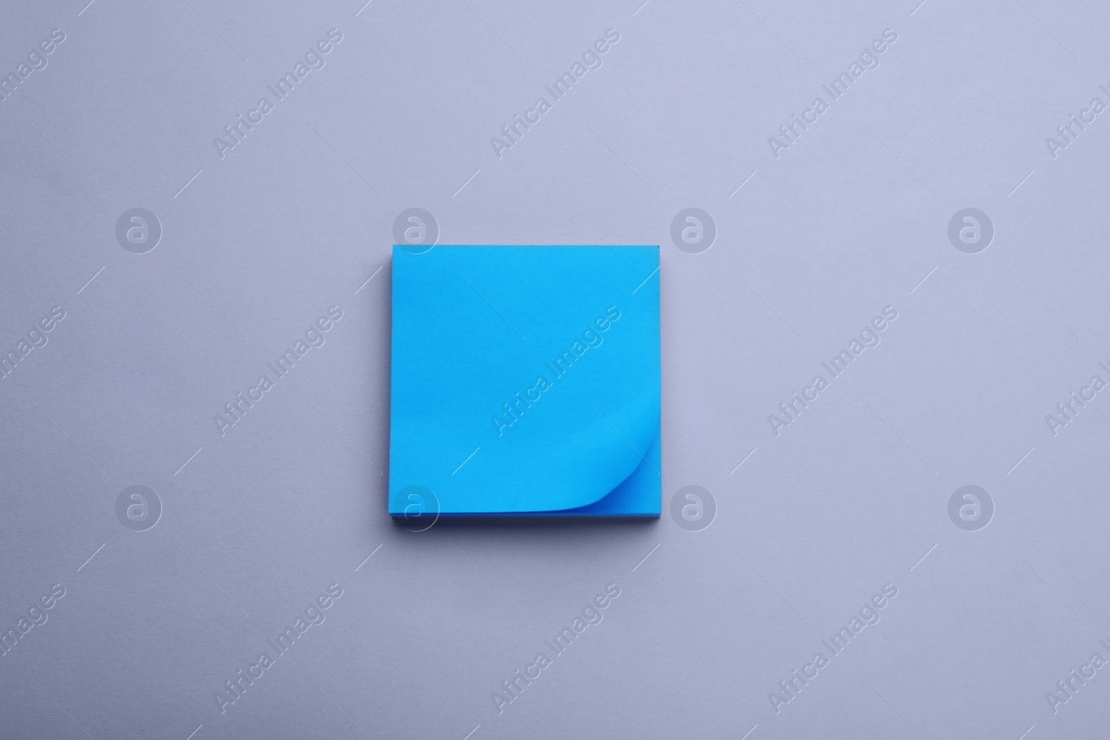 Photo of Paper note on light purple background, top view