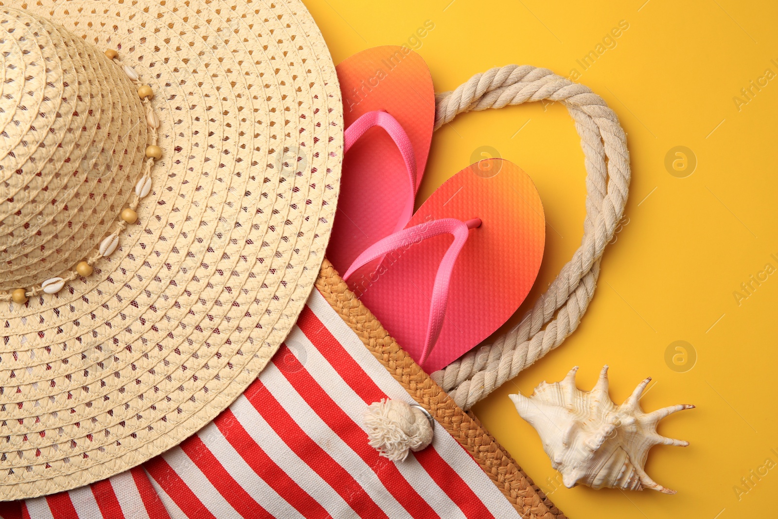 Photo of Flat lay composition with beach accessories on orange background