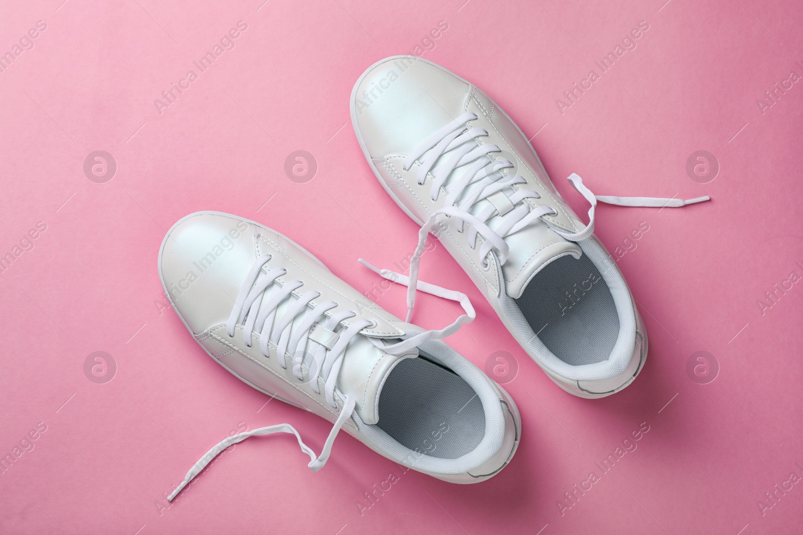 Photo of Pair of sneakers on color background, flat lay