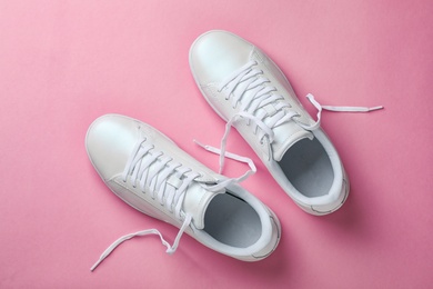 Photo of Pair of sneakers on color background, flat lay