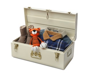 Photo of Stylish storage trunks with warm clothes, shoes and tiger toy on white background. Interior elements