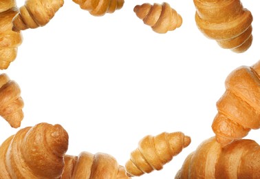 Crusty golden croissants falling on white background