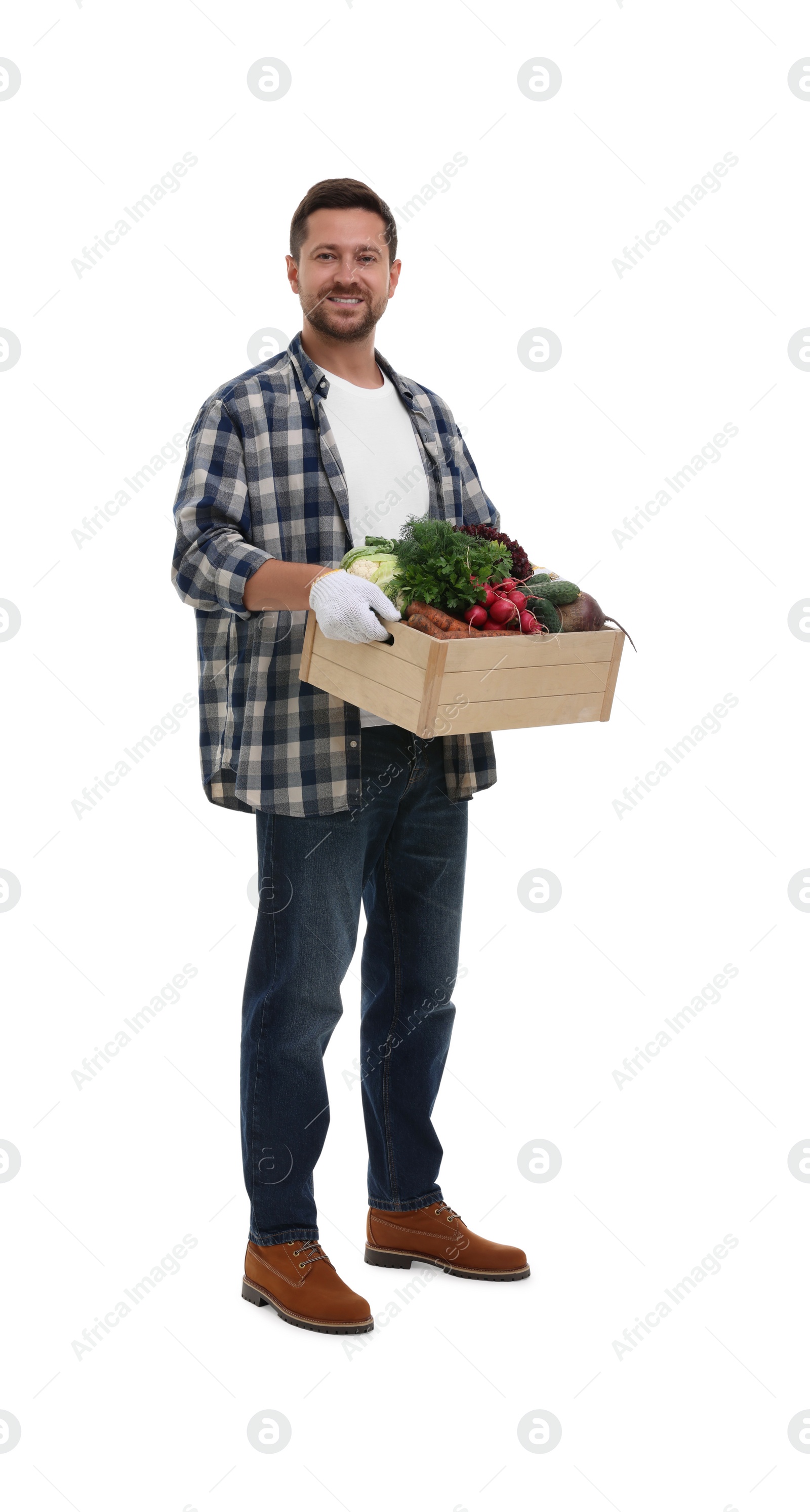 Photo of Harvesting season. Happy farmer holding wooden crate with vegetables on white background