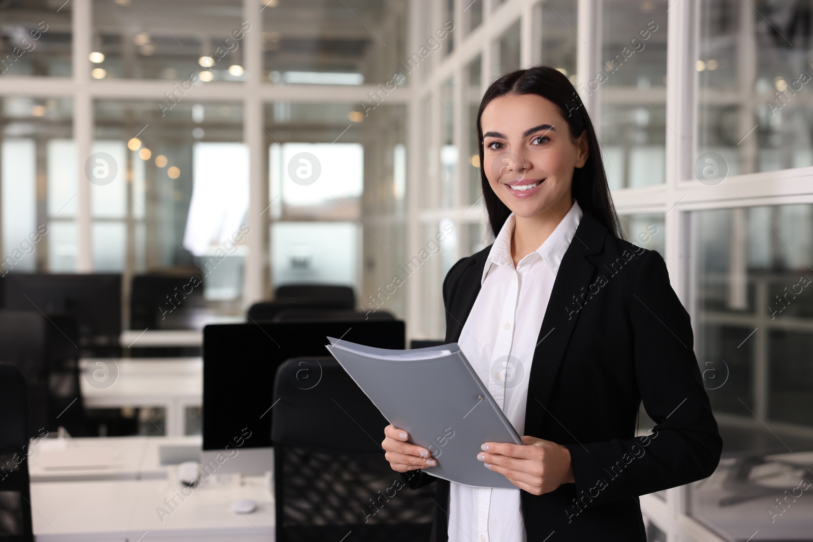 Photo of Happy woman with folder in office, space for text. Lawyer, businesswoman, accountant or manager