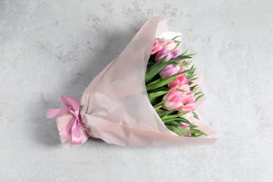 Bouquet of beautiful tulips on white table, top view