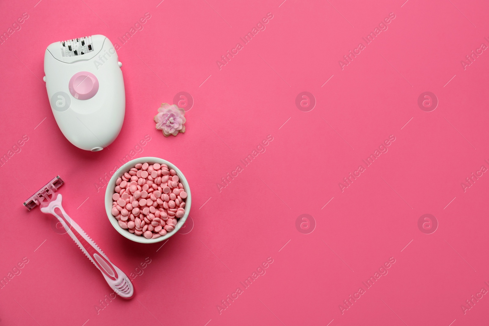 Photo of Set of epilation products on pink background, flat lay. Space for text