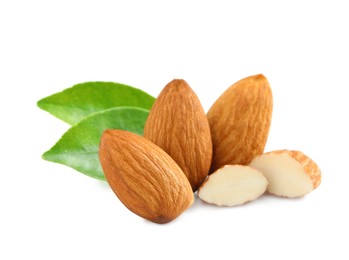 Photo of Organic almond nuts and green leaves on white background. Healthy snack