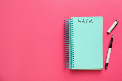 Notepad with inscription To Do List and pen on pink background, top view. Space for text