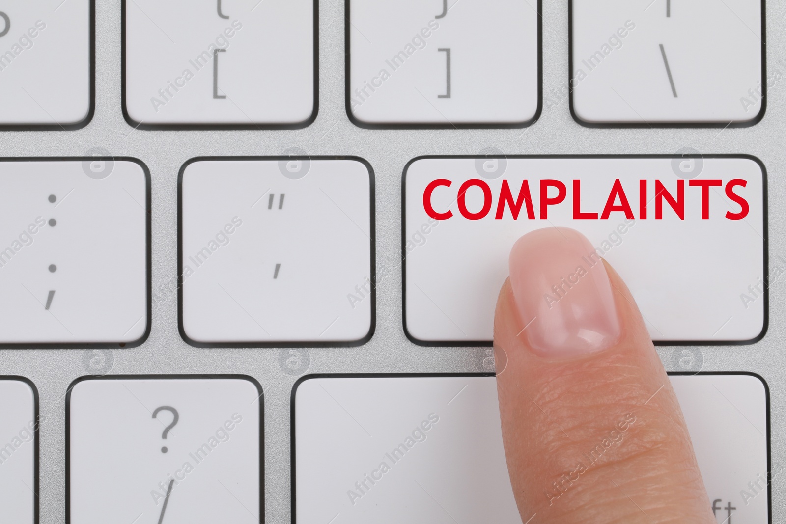 Image of Woman pressing button with word Complaints on computer keyboard, top view