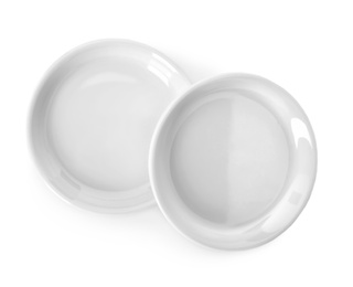 Photo of New ceramic plates on white background, top view