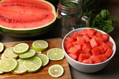Fresh ingredients for making watermelon drink with lime on wooden table