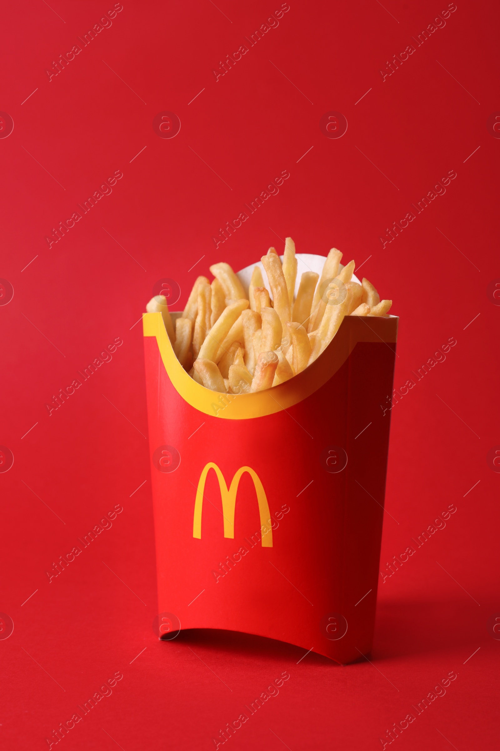 Photo of MYKOLAIV, UKRAINE - AUGUST 12, 2021: Big portion of McDonald's French fries on red background