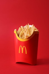 MYKOLAIV, UKRAINE - AUGUST 12, 2021: Big portion of McDonald's French fries on red background