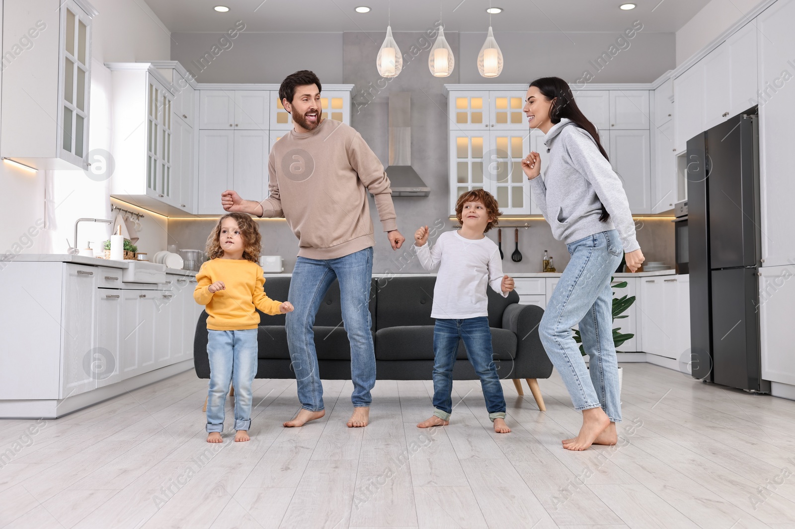 Photo of Happy family dancing and having fun at home, low angle view