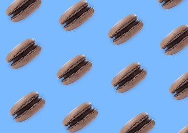 Delicious macarons on blue background, flat lay 