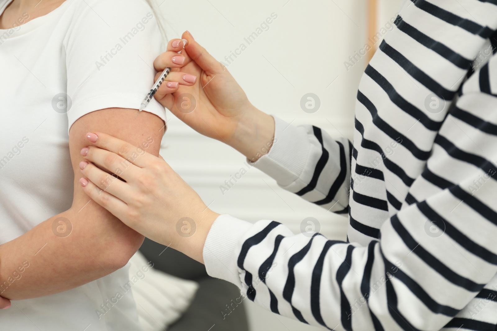 Photo of Diabetes. Woman getting insulin injection indoors, closeup