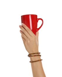 Woman holding elegant red cup on white background, closeup