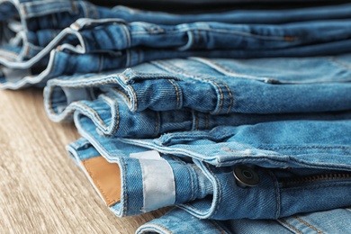 Jeans in different shades of blue on table, closeup