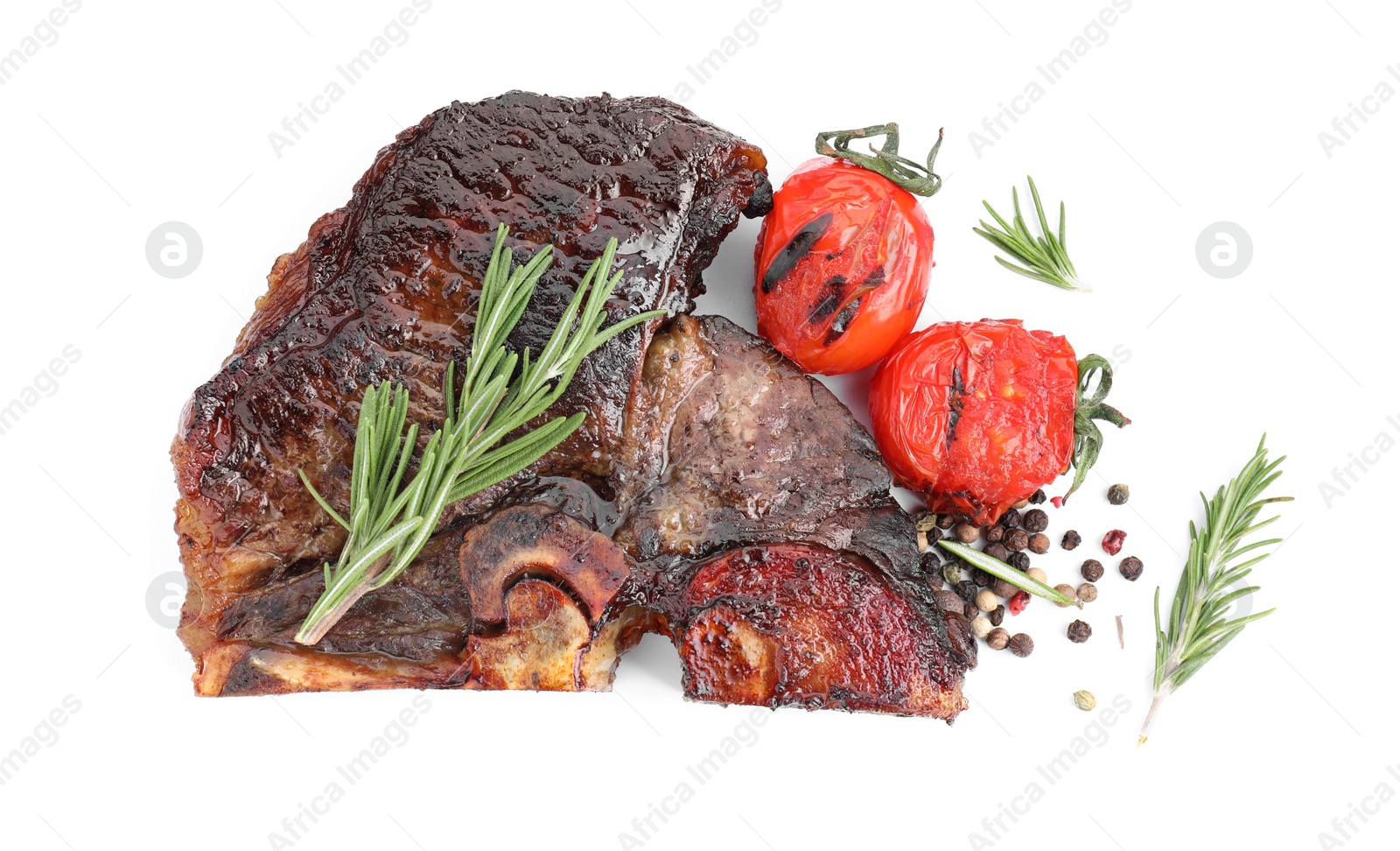 Photo of Piece of delicious grilled beef meat, tomatoes, peppercorns and rosemary isolated on white, top view