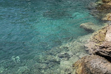 Photo of Shallow water with rocky sea bottom as background