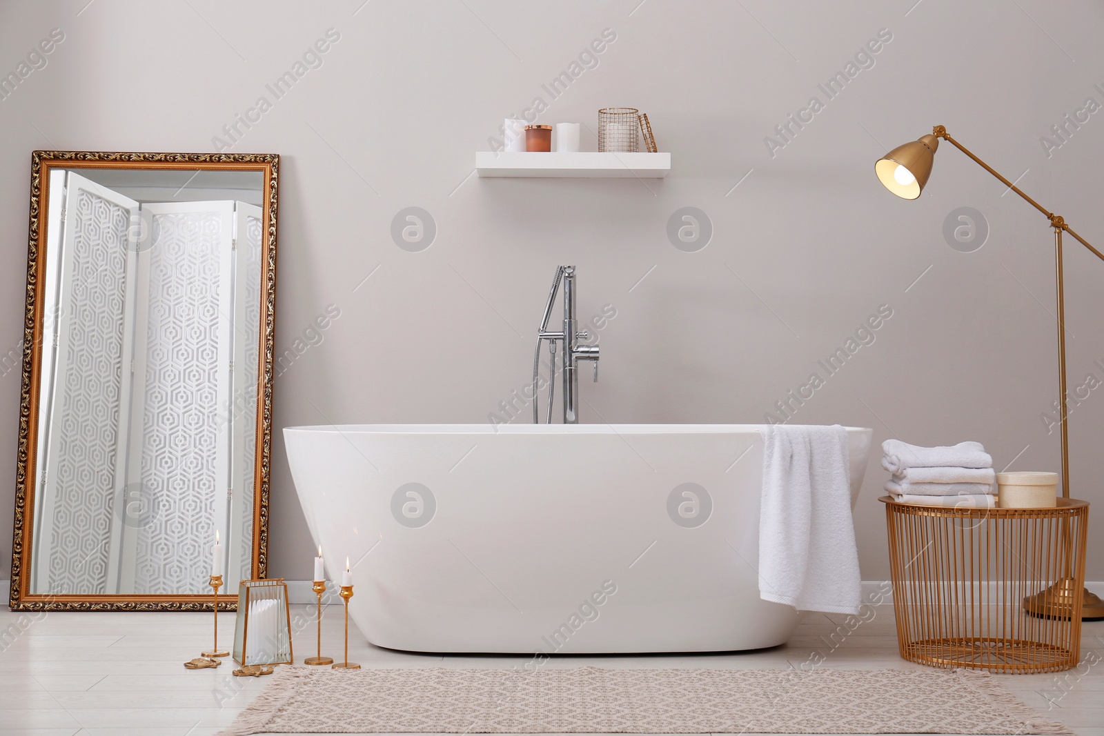 Photo of Stylish bathroom interior with modern white tub