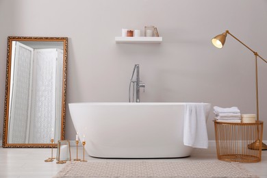 Stylish bathroom interior with modern white tub