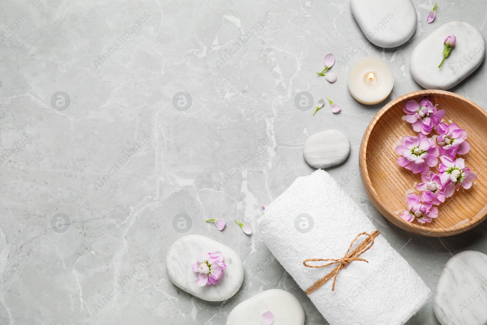 Photo of Flat lay composition with spa stones on light grey marble table, space for text