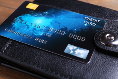 Photo of Credit card and leather wallet on table, closeup