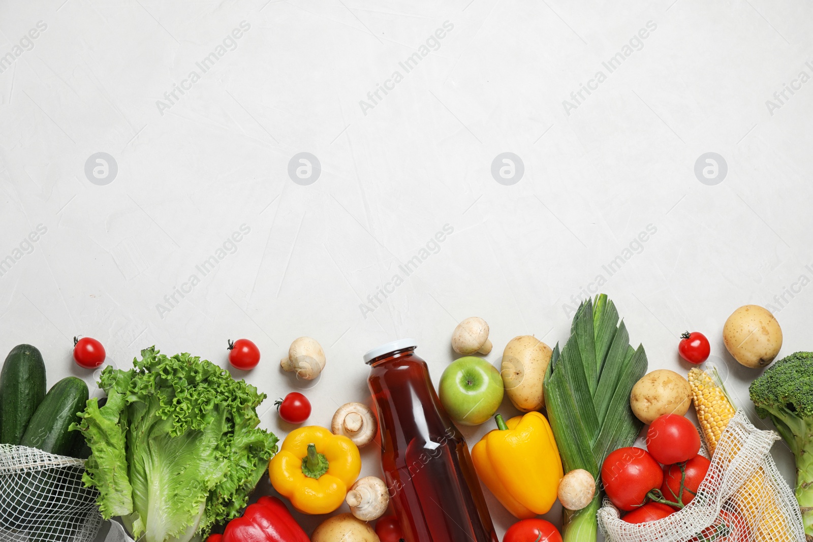 Photo of Fresh vegetables and other products on light grey background, flat lay. Space for text