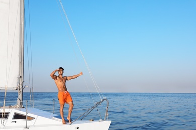Young man relaxing on yacht during sea trip