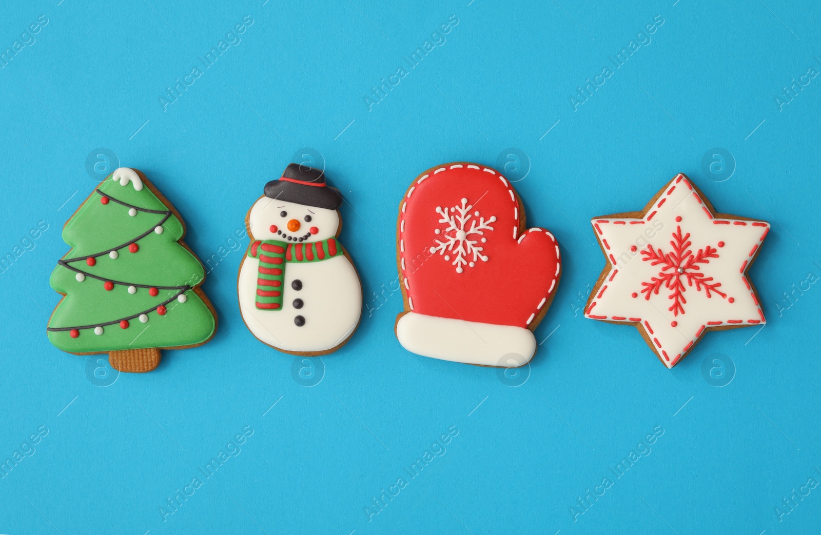 Photo of Different Christmas gingerbread cookies on light blue background, flat lay