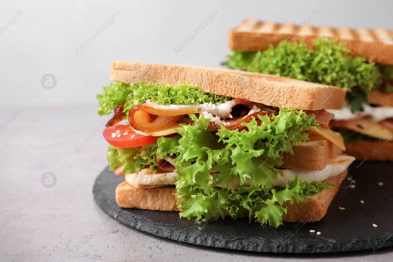 Photo of Freshly made sandwiches served on grey table