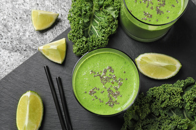 Photo of Flat lay composition with tasty kale smoothie on grey table