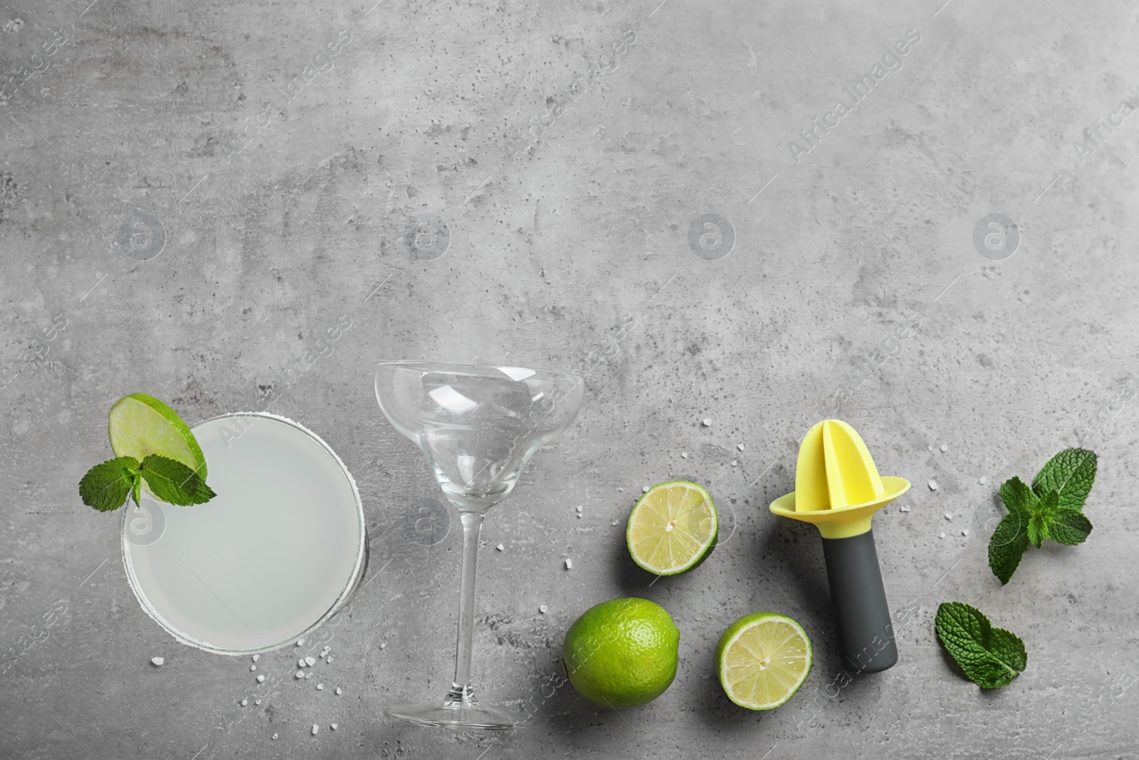 Photo of Flat lay composition with tasty refreshing cocktail on grey background. Space for text