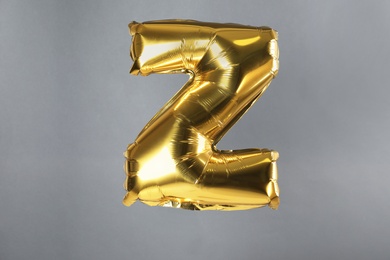 Photo of Golden letter Z balloon on grey background