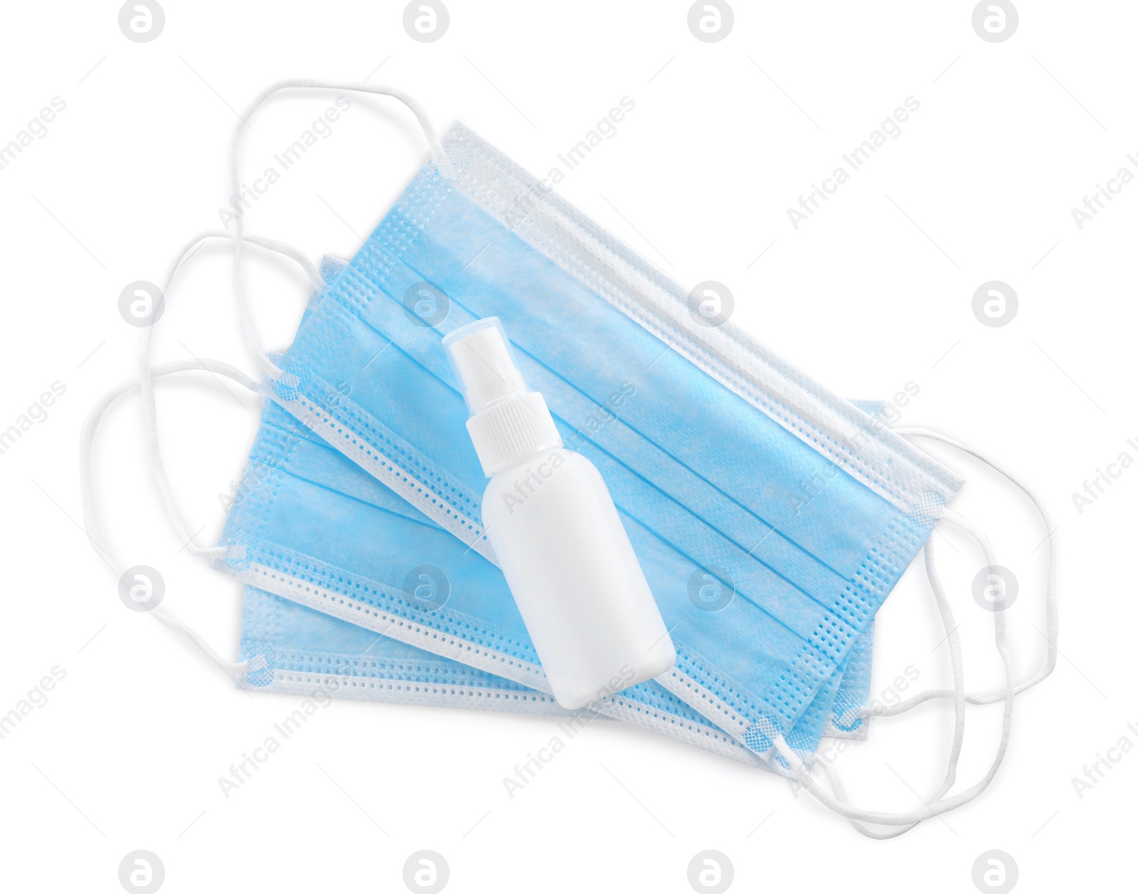 Photo of Protective masks and antiseptic on white background, top view