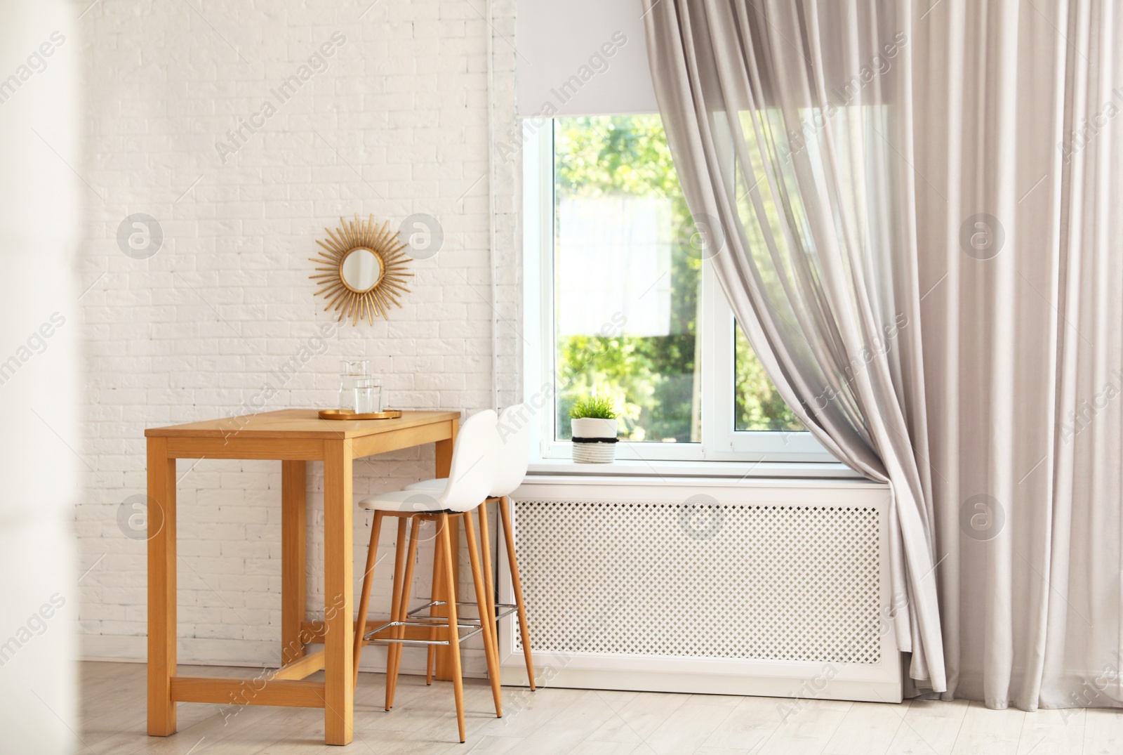 Photo of Modern room interior with wooden dining table. Space for text