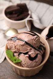 Bowl of tasty chocolate ice cream on table