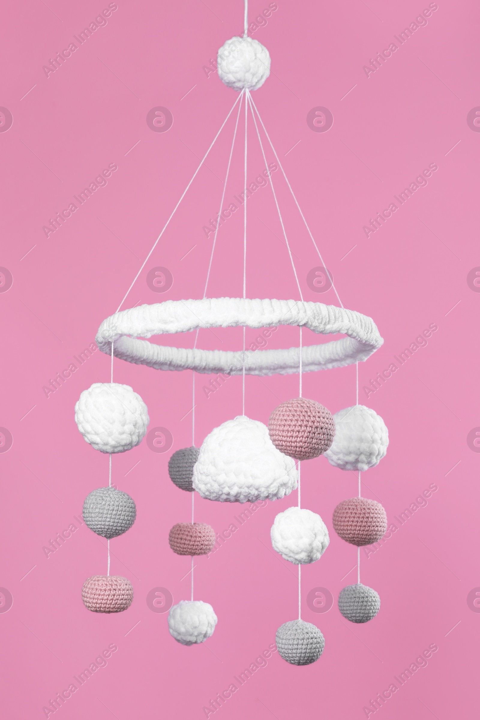 Photo of Cute baby crib mobile on pink background