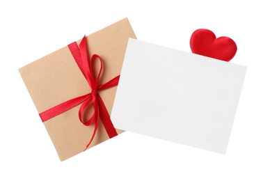 Photo of Blank card, envelope and red decorative heart on white background, top view. Valentine's Day celebration