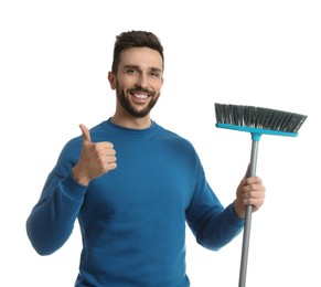 Handsome man with broom on white background