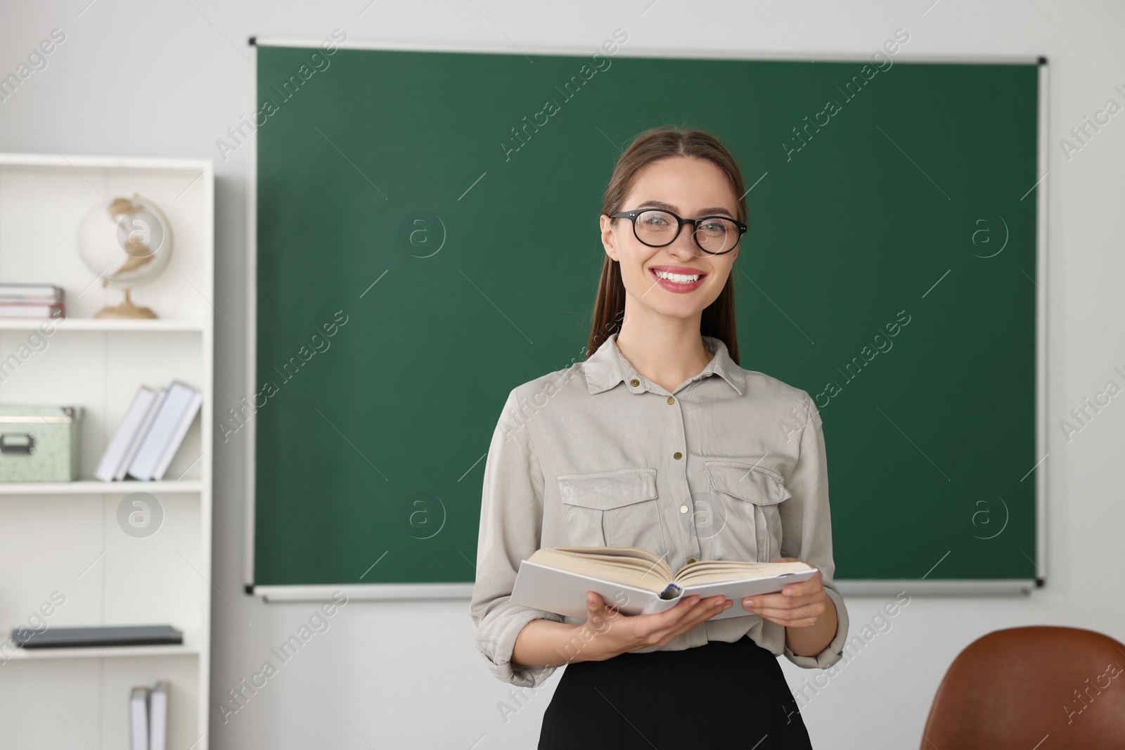 Photo of Portrait of beautiful young teacher in classroom