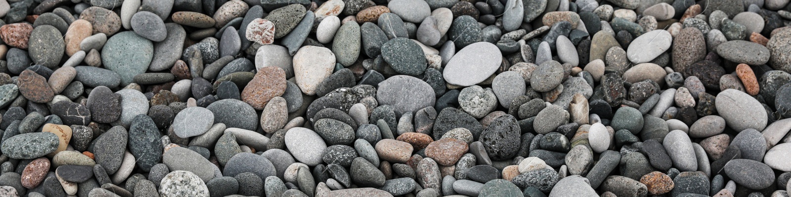 Image of Many different pebbles as background, top view. Banner design